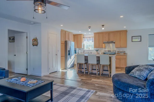 a living room with furniture and kitchen view