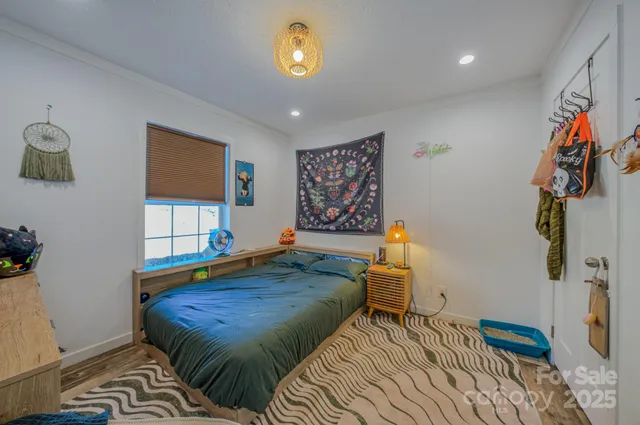 a bedroom with a bed and a window