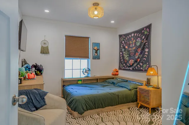 a bedroom with a bed and a couch