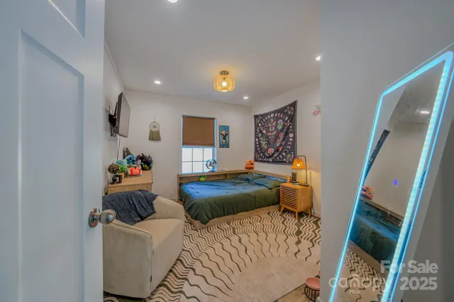 a bedroom with furniture and a wooden floor