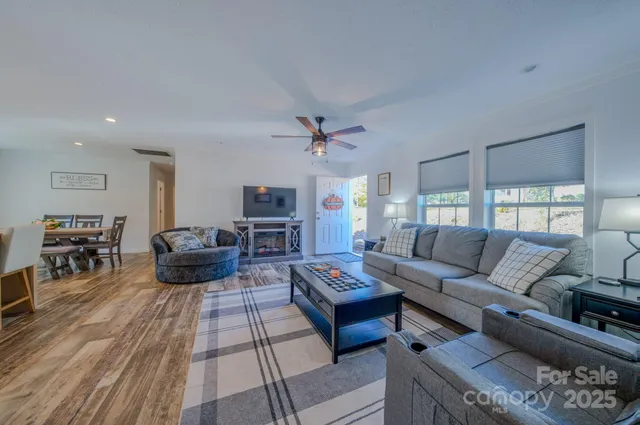 a living room with furniture and a wooden floor