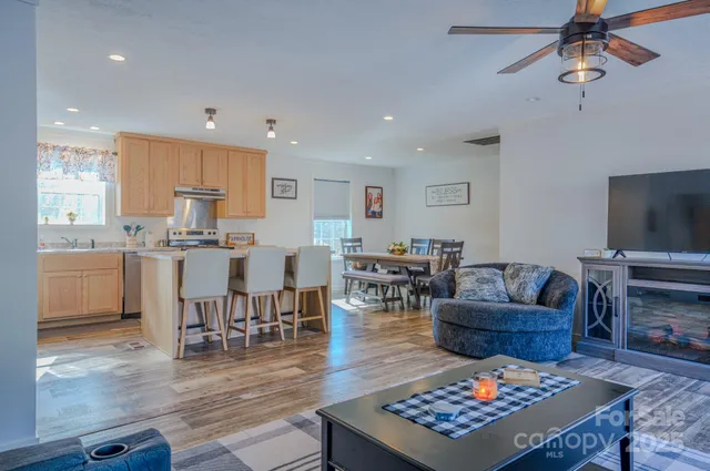 a living room with lots of furniture and kitchen view