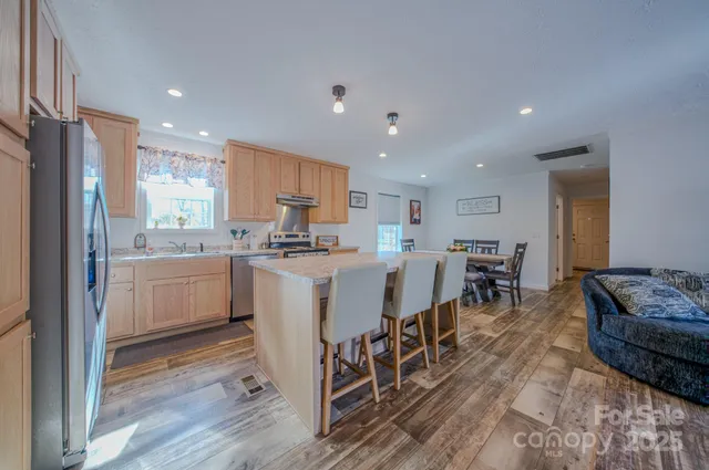 a kitchen with a sink a counter top stainless steel appliances and cabinets