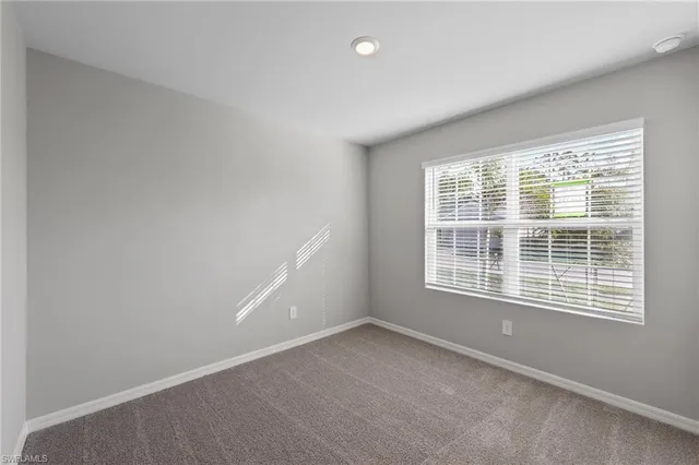 a big room with wooden floor and windows