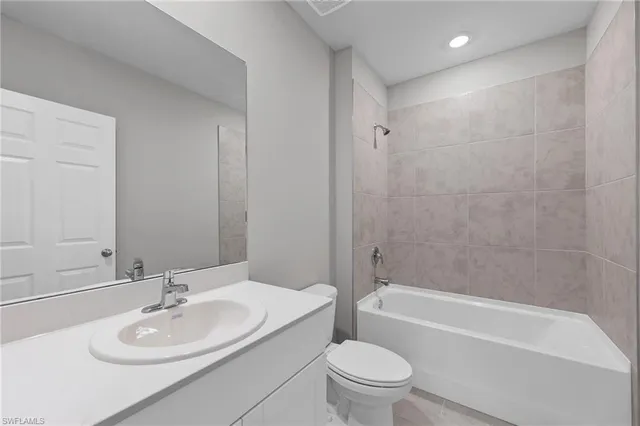 a bathroom with a sink a toilet and bathtub