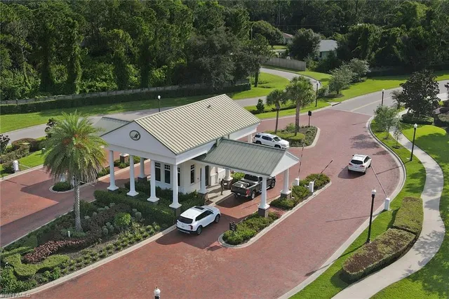 an aerial view of a house with garden space and lake view