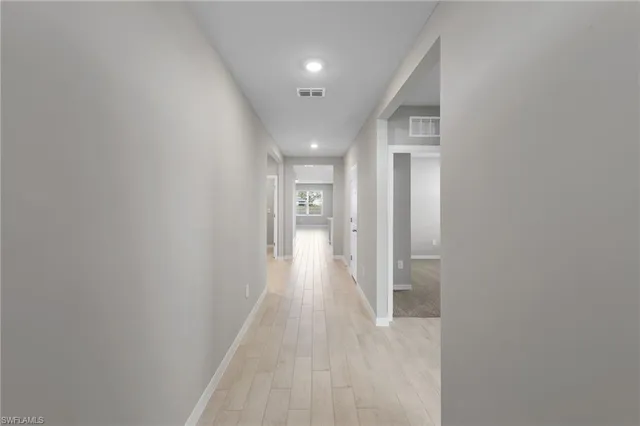 a view of hallway with wooden floor