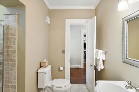 a bathroom with a toilet a sink and shower