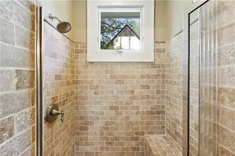 a bathroom with a window and a shower