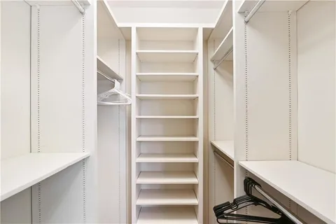 a bathroom with a granite countertop sink double vanity and mirror