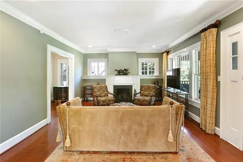a living room with fireplace furniture and a flat screen tv