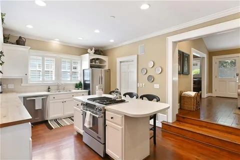a kitchen with a sink stove and cabinets