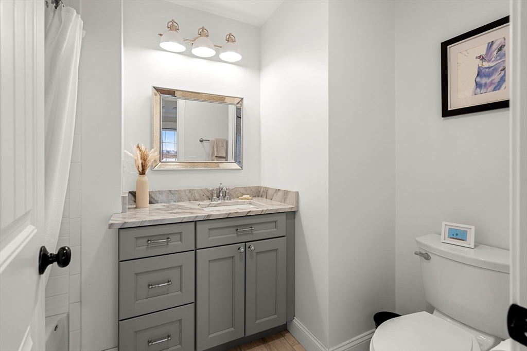 45 Old County Road, Unit 1 Salisbury, MA 01952 - Photo 15 of 40 a bathroom with a toilet sink and mirror