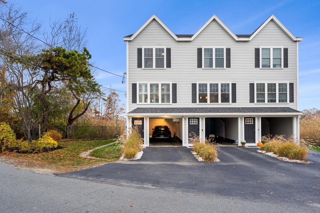 45 Old County Road, Unit 1 Salisbury, MA 01952 - Photo 2 of 40 a view of a white house with large windows next to a road