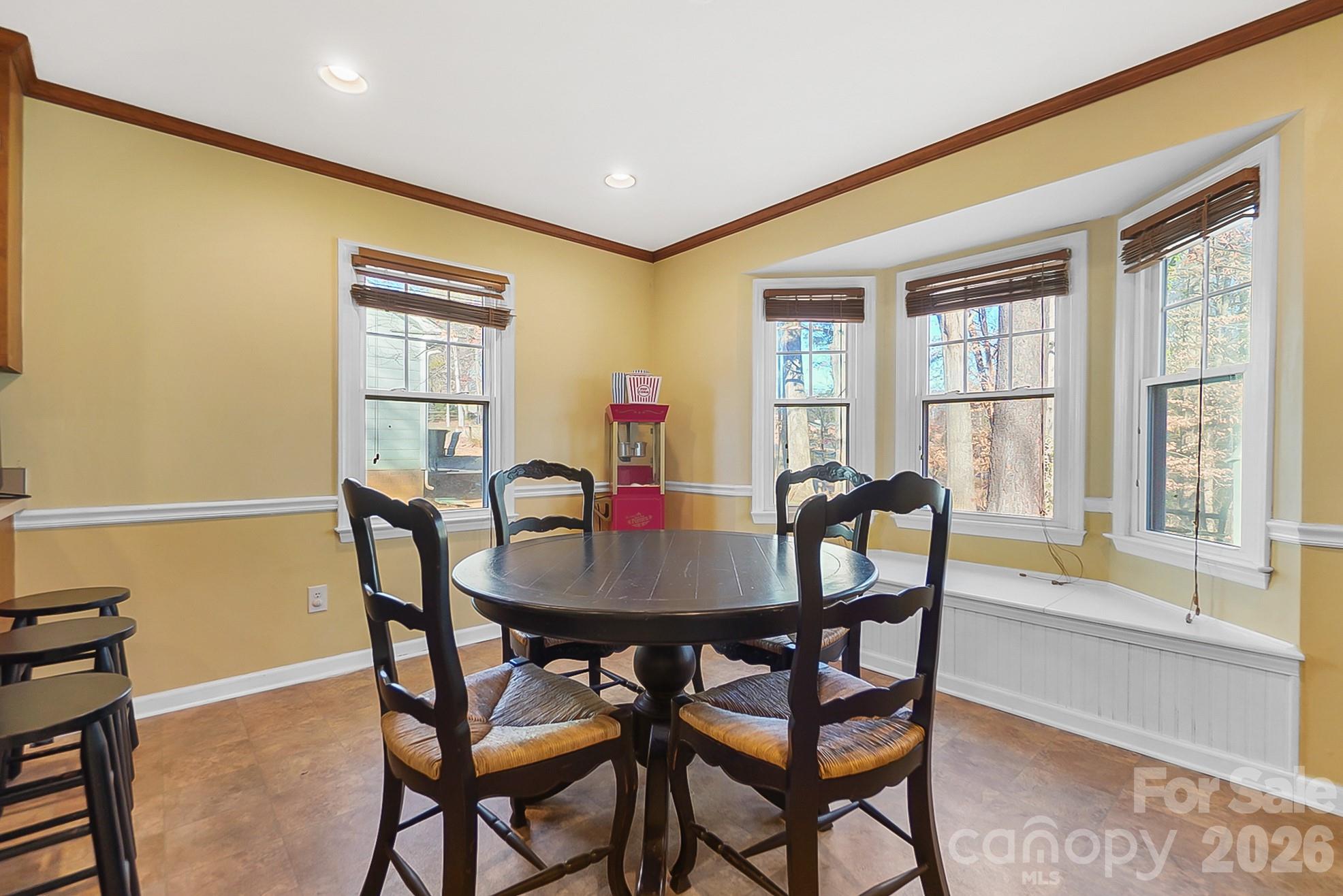 6906 Streamside Drive Charlotte, NC 28212 - Photo 11 of 48 a view of a dining room with furniture and window