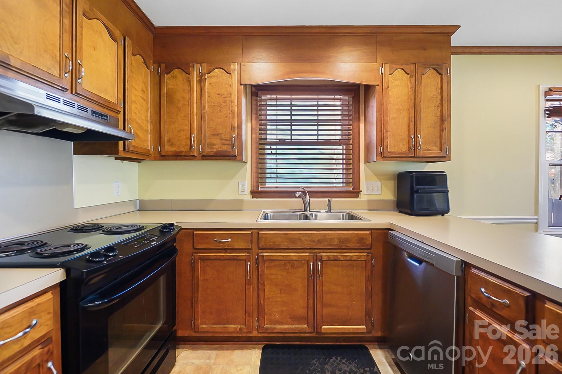 6906 Streamside Drive Charlotte, NC 28212 - Photo 15 of 48 a kitchen with stainless steel appliances granite countertop a sink stove and cabinets
