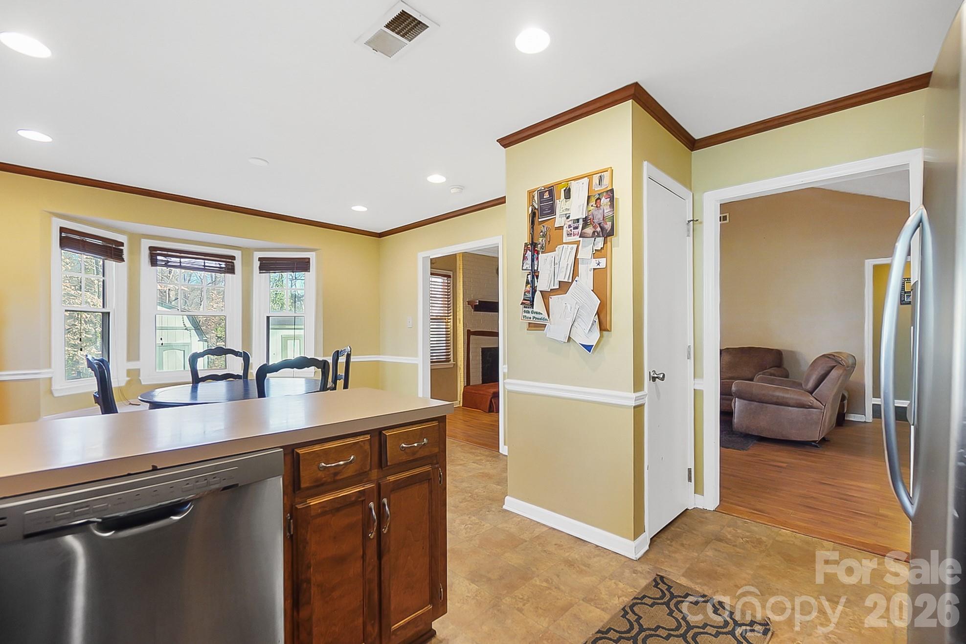 6906 Streamside Drive Charlotte, NC 28212 - Photo 16 of 48 a open kitchen with stainless steel appliances granite countertop a refrigerator and stove