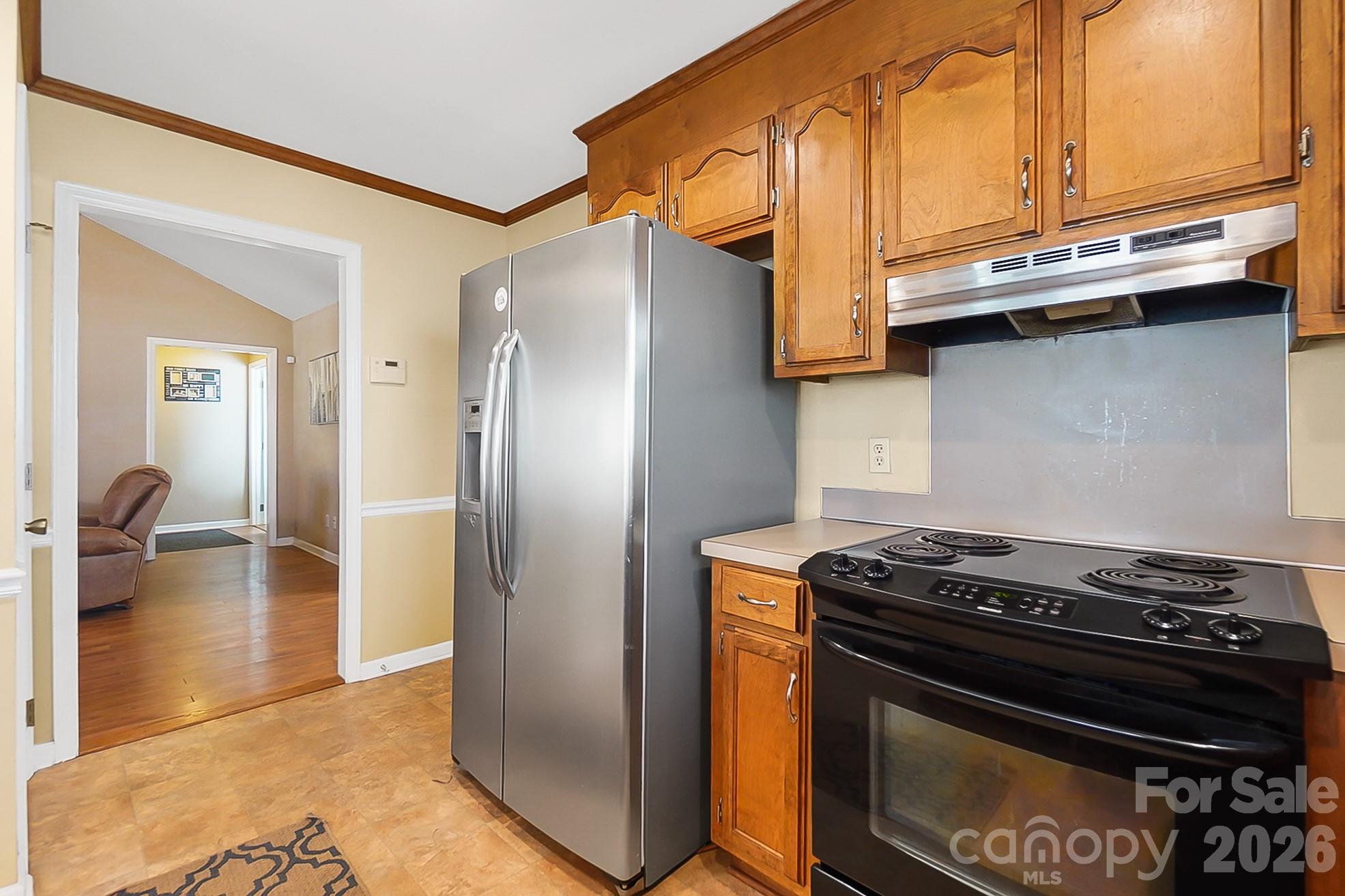6906 Streamside Drive Charlotte, NC 28212 - Photo 17 of 48 a kitchen with stainless steel appliances granite countertop a stove and a refrigerator