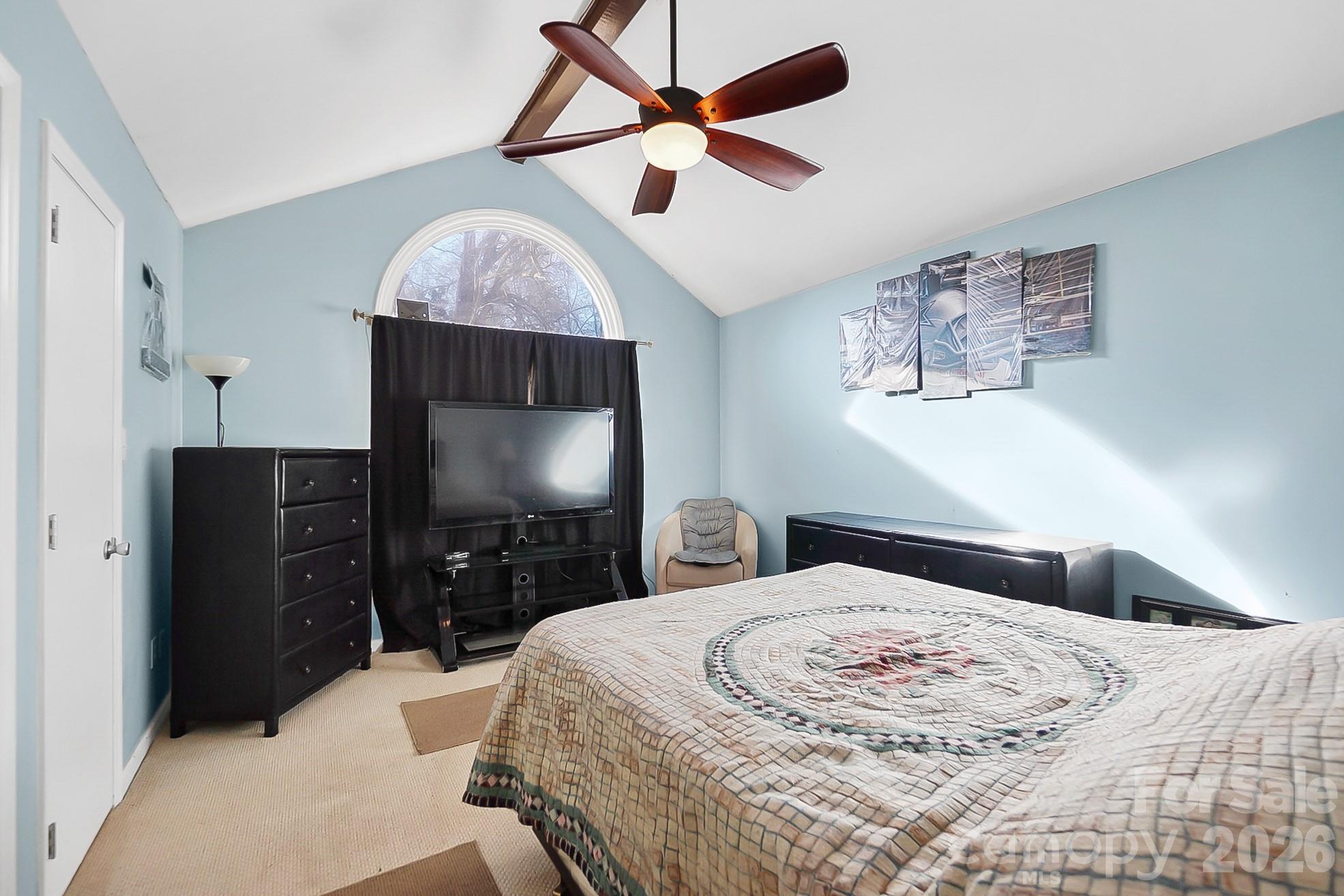 6906 Streamside Drive Charlotte, NC 28212 - Photo 18 of 48 a bedroom with a bed and a flat screen tv