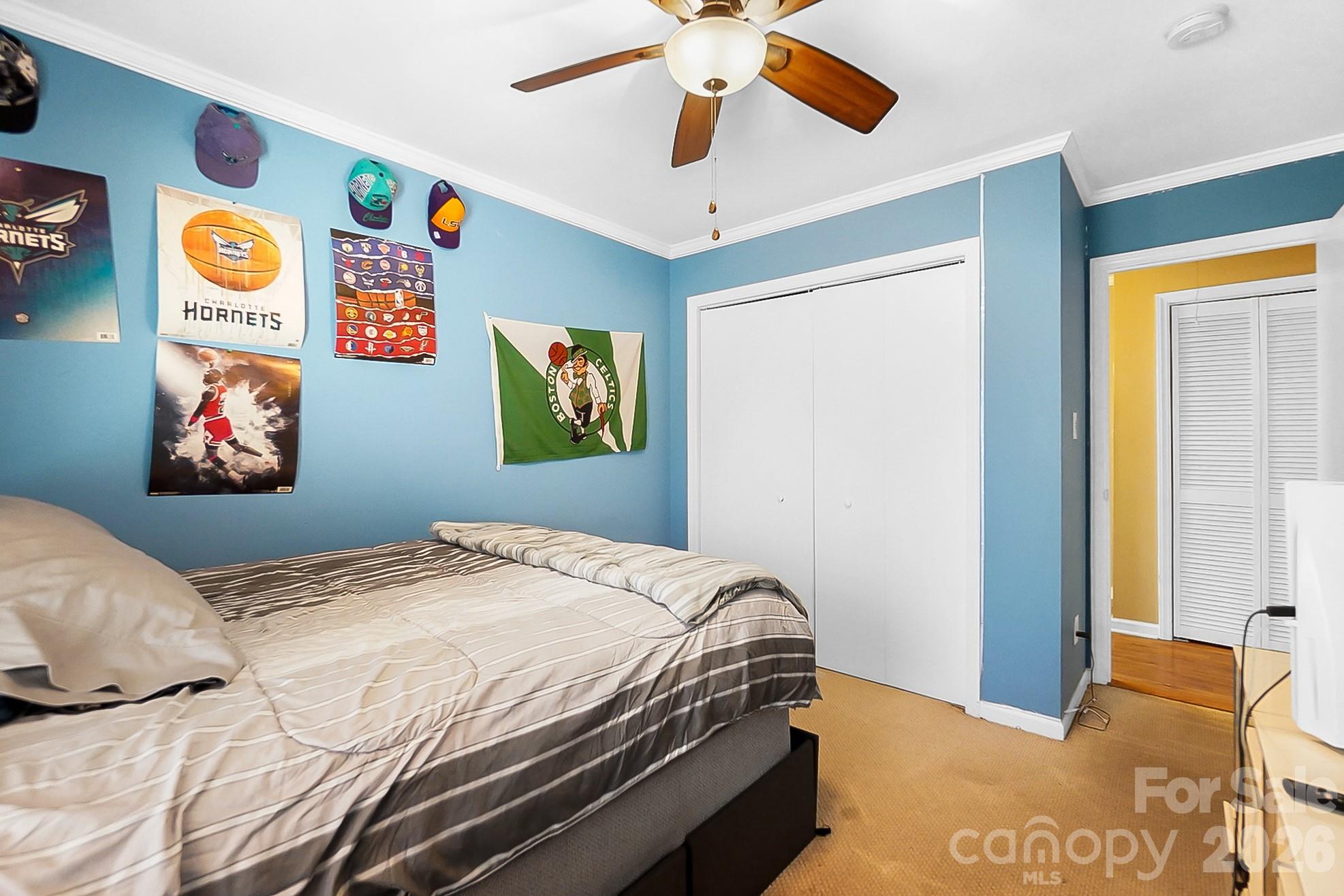 6906 Streamside Drive Charlotte, NC 28212 - Photo 26 of 48 a bedroom with a bed and a painting on the wall