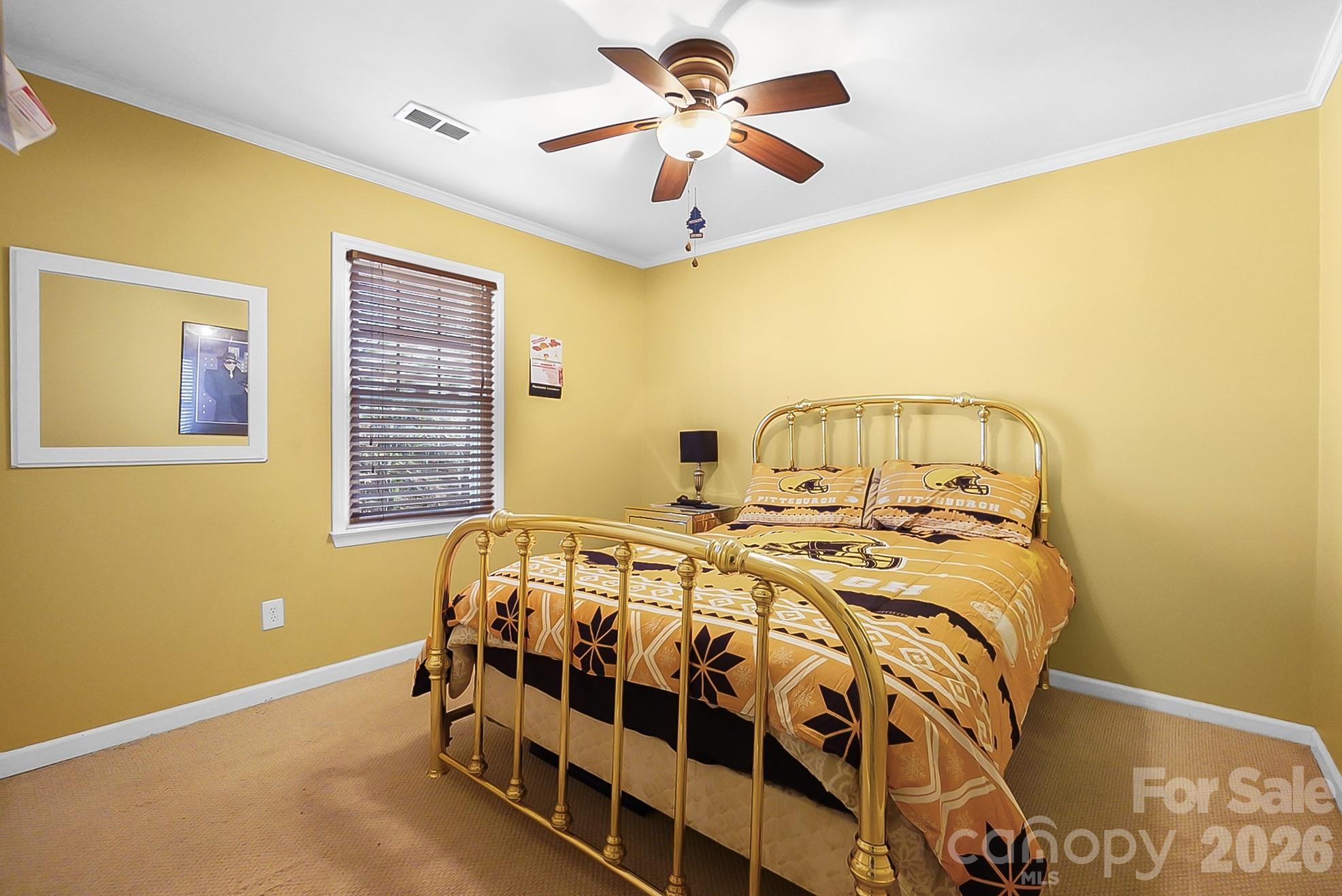 6906 Streamside Drive Charlotte, NC 28212 - Photo 28 of 48 a bedroom with a bed and a chandelier