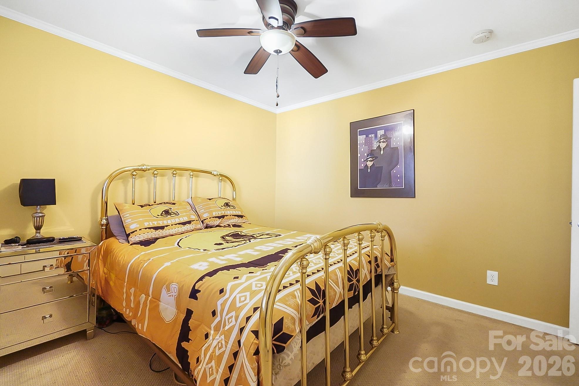 6906 Streamside Drive Charlotte, NC 28212 - Photo 29 of 48 a bedroom with a bed and a chandelier