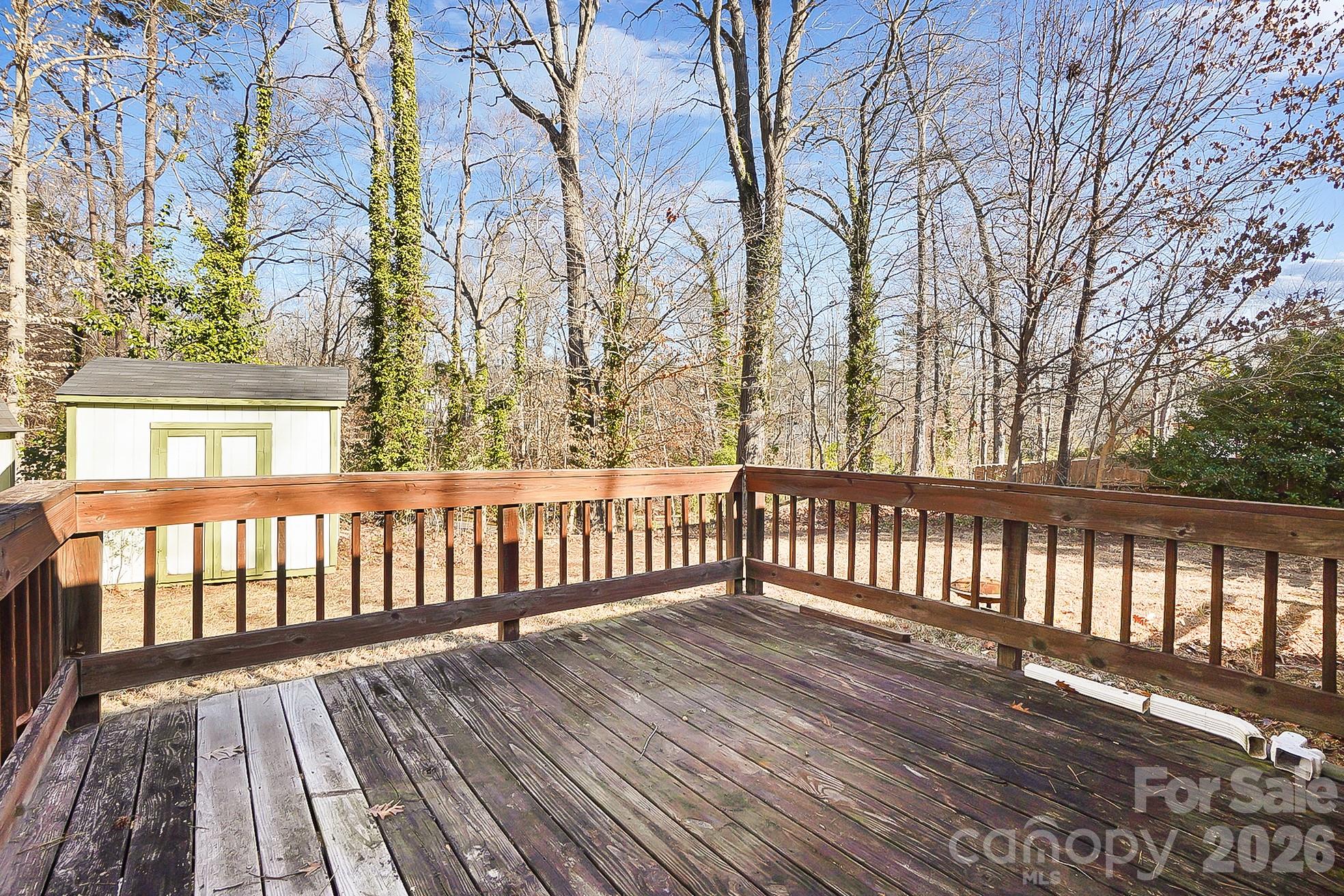6906 Streamside Drive Charlotte, NC 28212 - Photo 36 of 48 a view of wooden balcony with trees