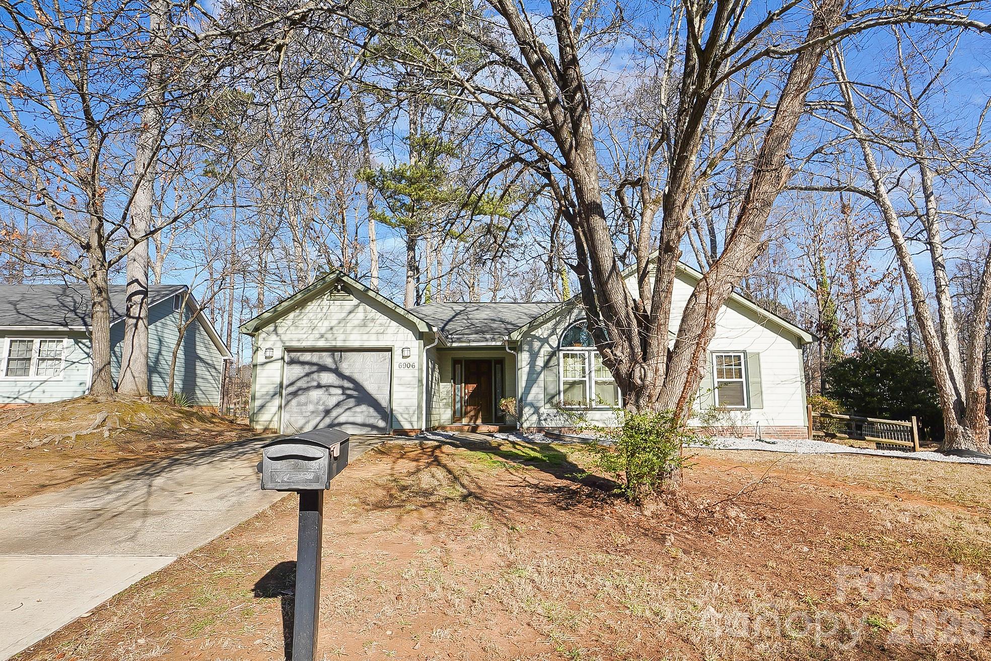 6906 Streamside Drive Charlotte, NC 28212 - Photo 46 of 48 a front view of a house with yard tree and tree