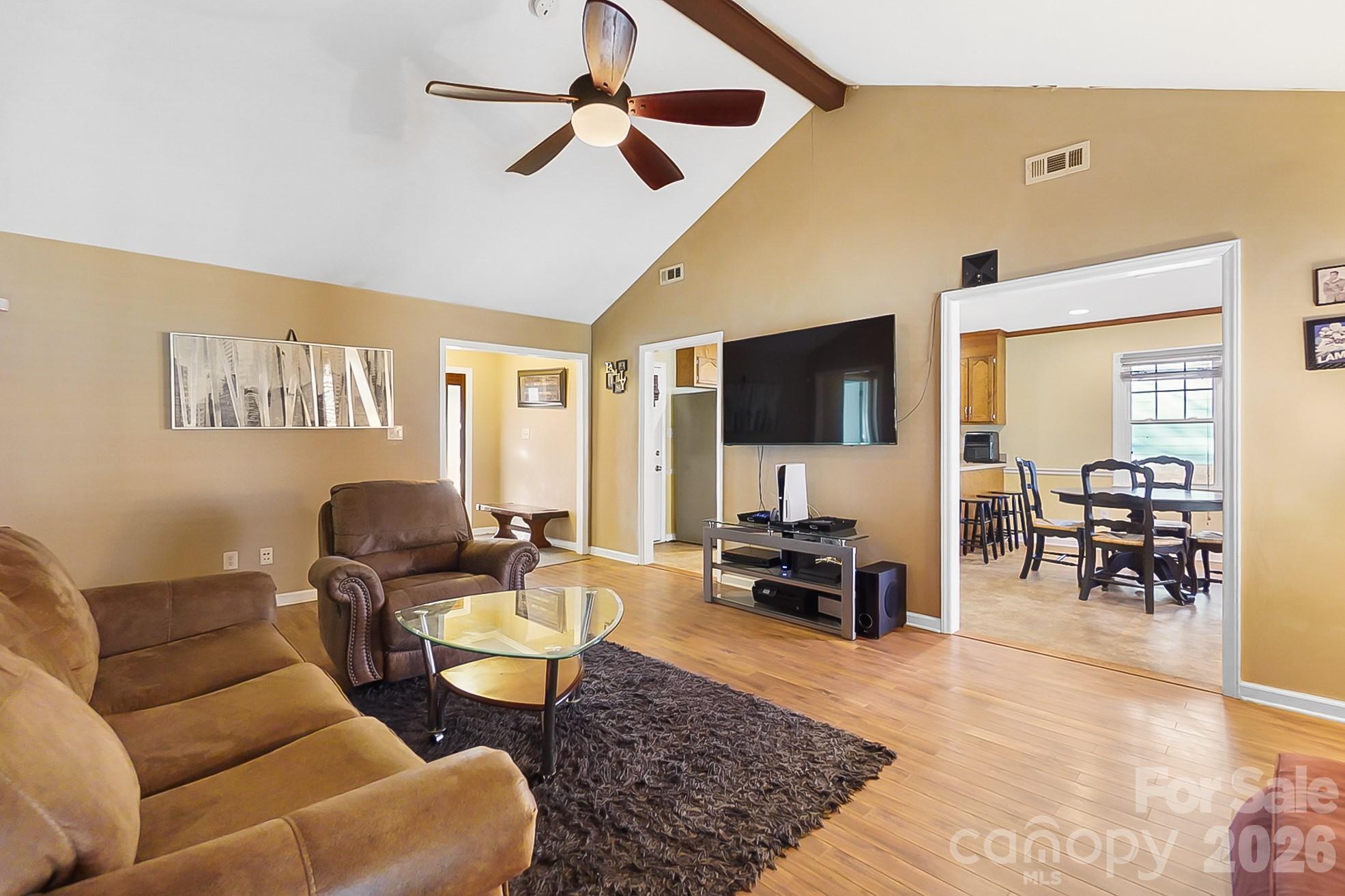 6906 Streamside Drive Charlotte, NC 28212 - Photo 8 of 48 a living room with furniture and a flat screen tv