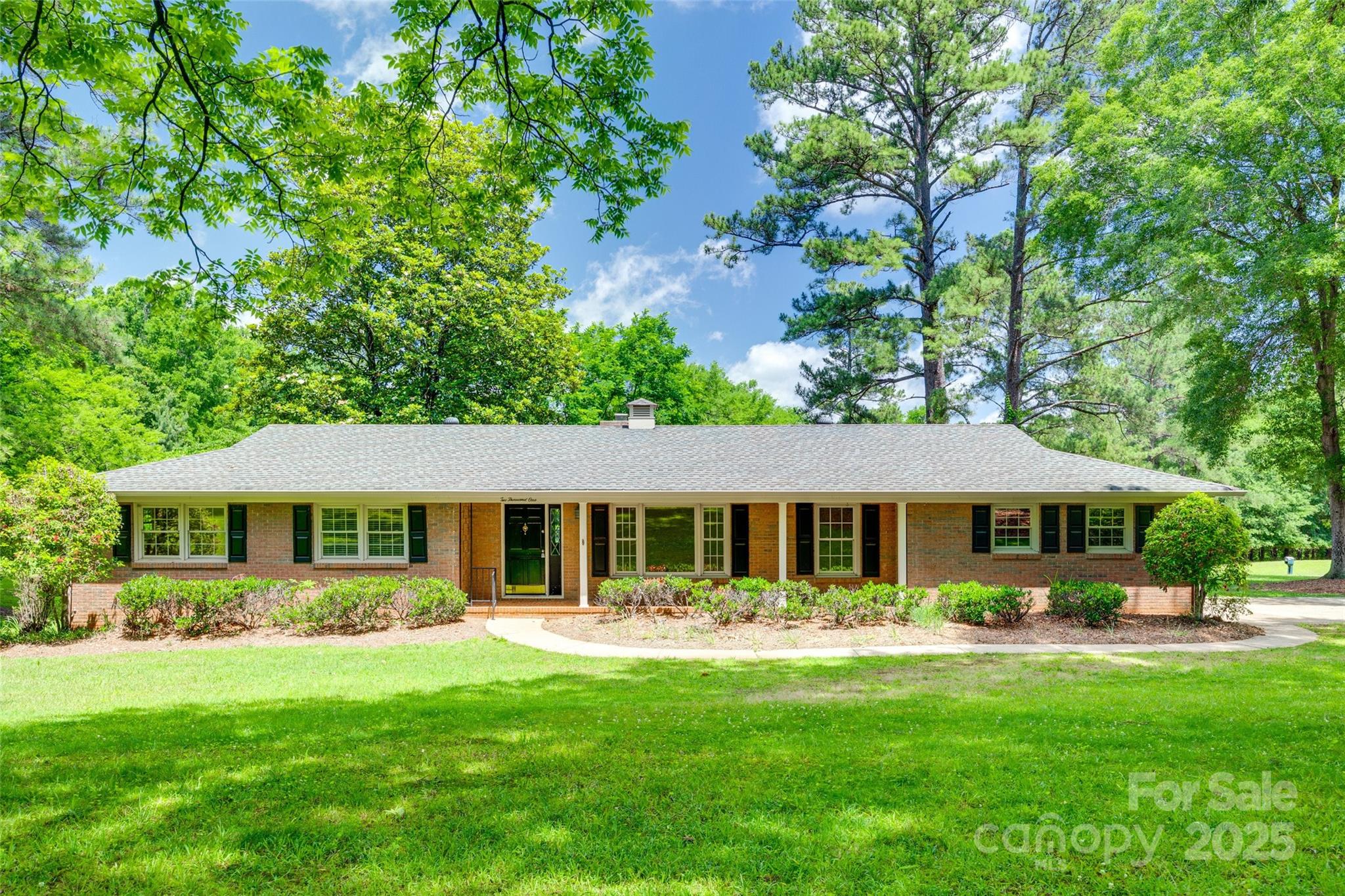 a front view of a house with a yard table and chairs