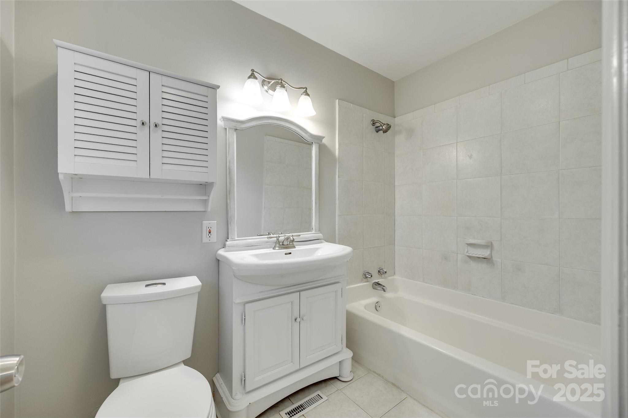 2001 Lakeview Drive Pineville, NC 28134 - Photo 17 of 35 a bathroom with a toilet sink and mirror