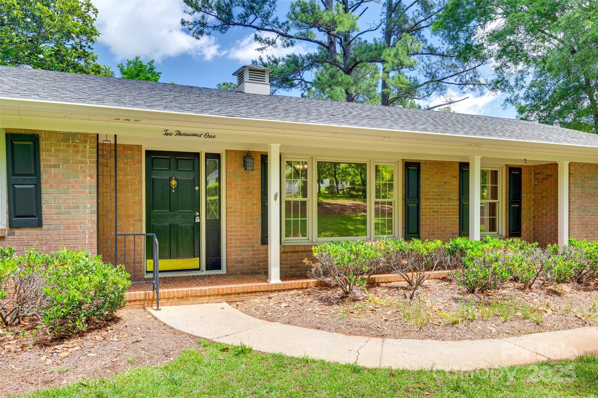 2001 Lakeview Drive Pineville, NC 28134 - Photo 2 of 35 a view of brick house with potted plants and a table and chair