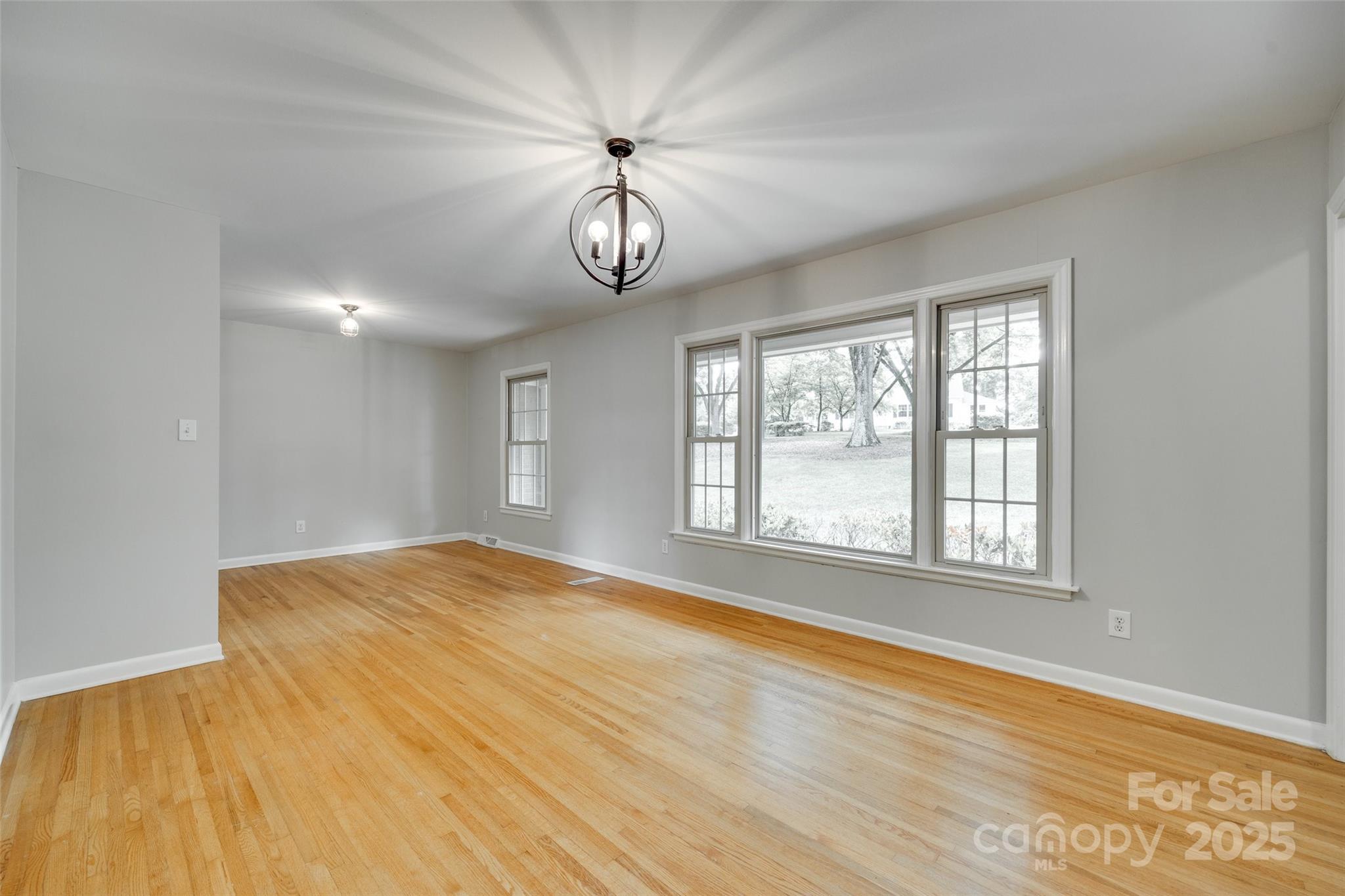 2001 Lakeview Drive Pineville, NC 28134 - Photo 4 of 35 a view of an empty room with a window and wooden floor