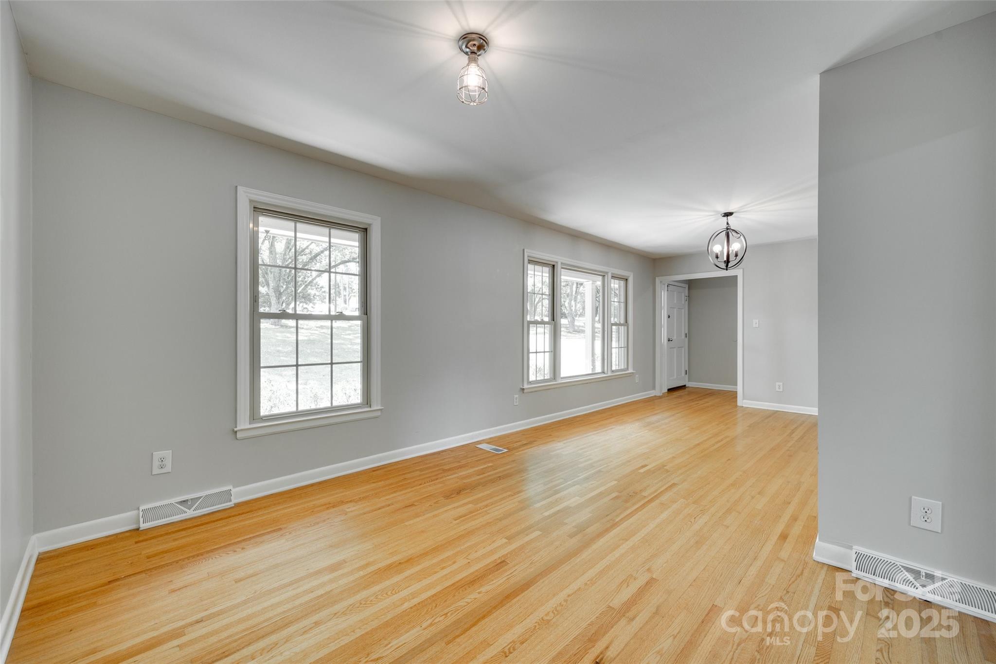 2001 Lakeview Drive Pineville, NC 28134 - Photo 7 of 35 an empty room with wooden floor and windows
