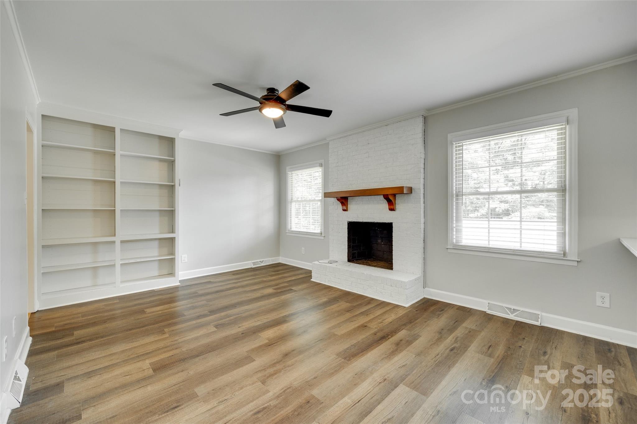 2001 Lakeview Drive Pineville, NC 28134 - Photo 9 of 35 a view of empty room with a fireplace and wooden floor