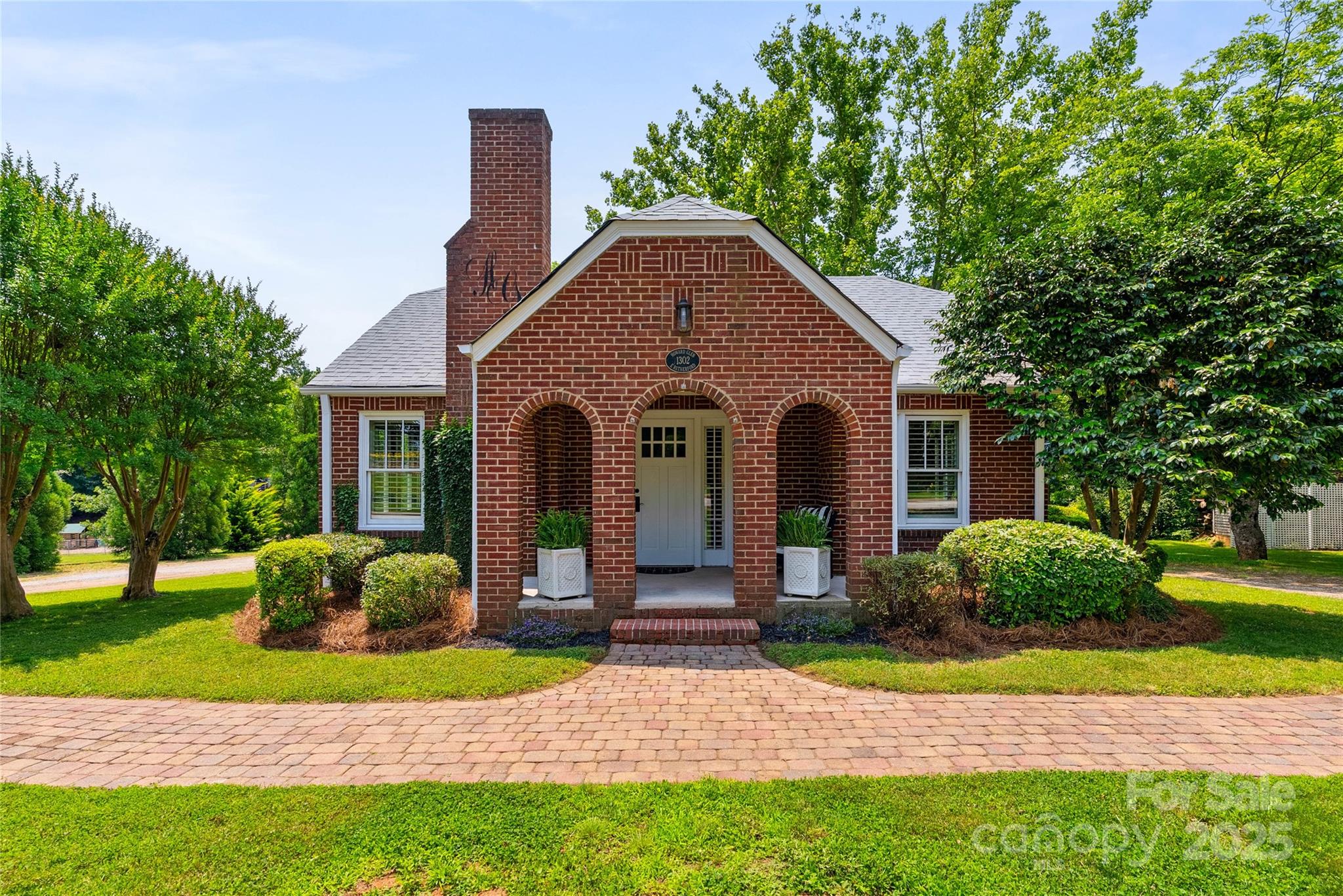 1302 East Rutherford Street Landrum, SC 29356 - Photo 1 of 47 a front view of a house with garden