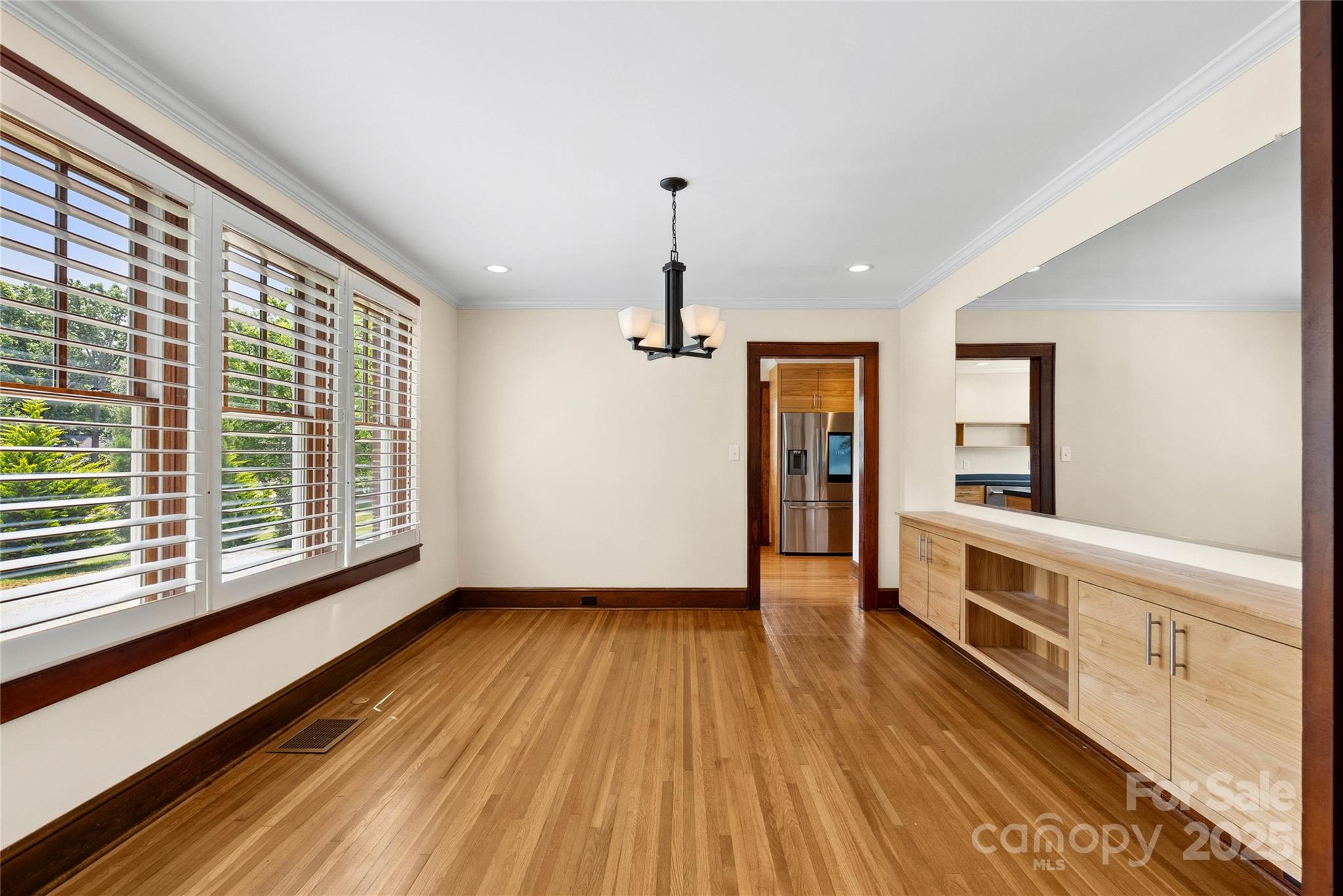 1302 East Rutherford Street Landrum, SC 29356 - Photo 20 of 47 a view of an empty room with wooden floor and a window