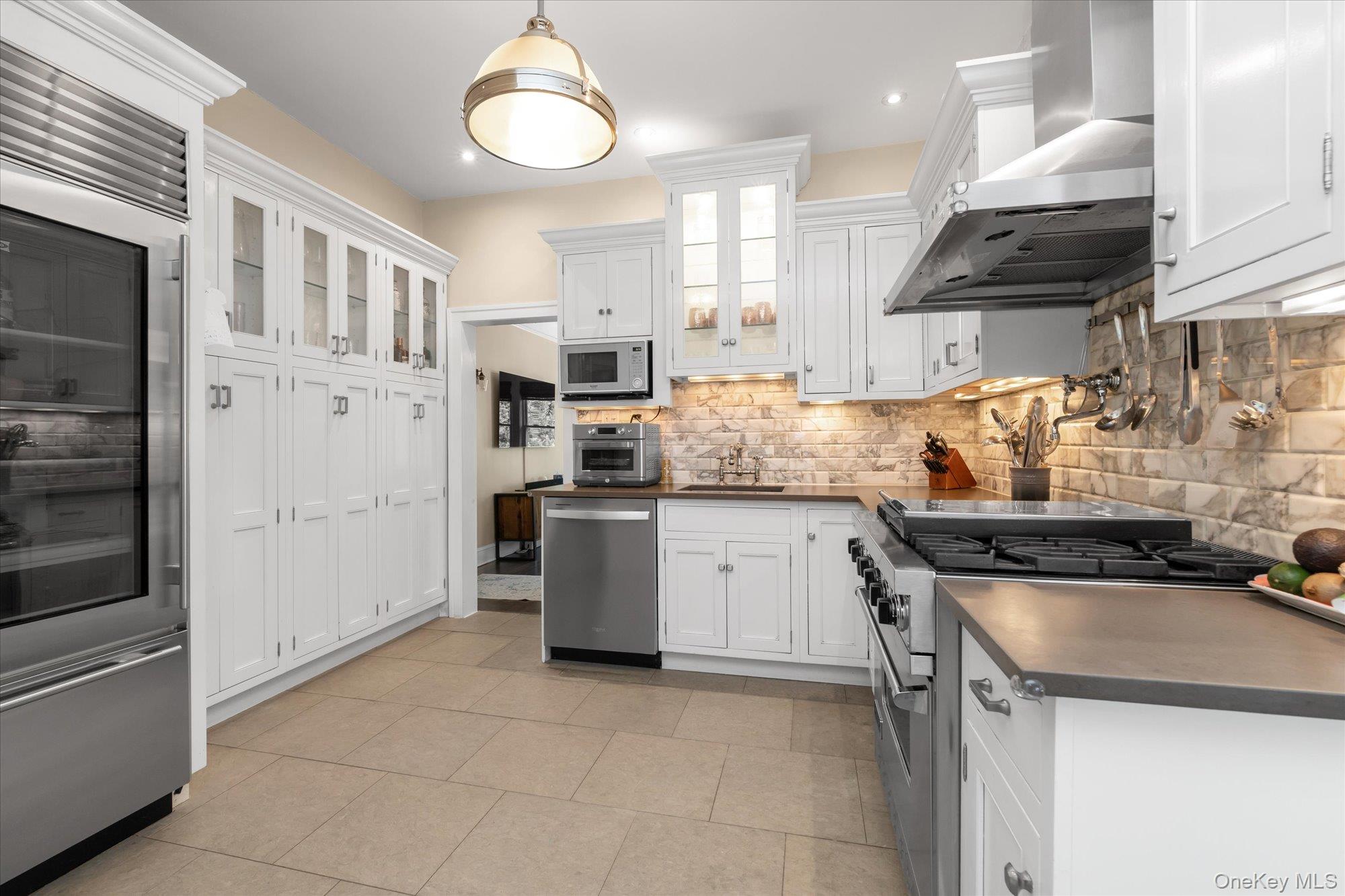 80 Skunks Misery Road Locust Valley, NY 11560 - Photo 12 of 25 a kitchen with stainless steel appliances granite countertop a stove and a sink