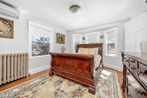 a bedroom with furniture and a window