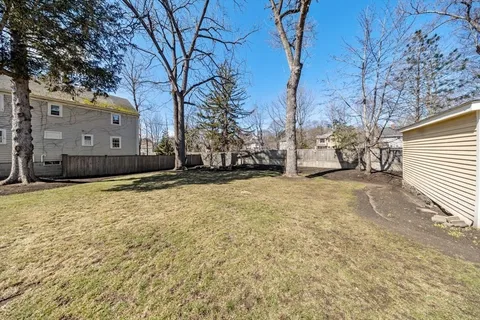 a view of a house with a yard covered with snow