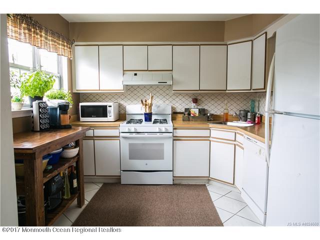 210 Osprey Court Tuckerton, NJ 08087 - Photo 7 of 24 a kitchen with white cabinets and white appliances