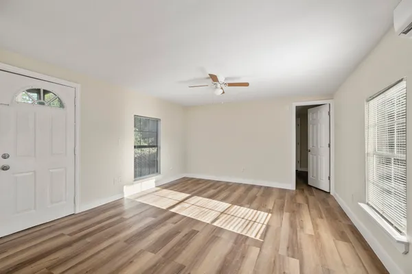 wooden floor in an empty room with a window