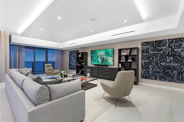 a bedroom with a large bed and a flat screen tv