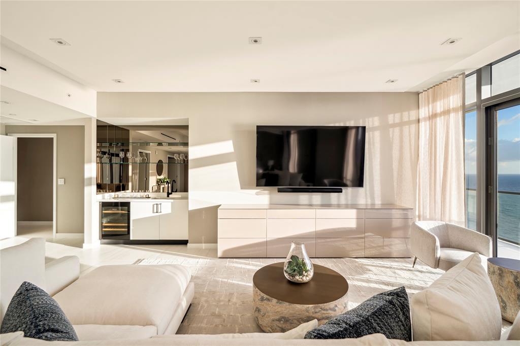 1116 North Ocean Boulevard, Unit UPH03 Pompano Beach, FL 33062 - Photo 24 of 84 a living room with furniture and a flat screen tv