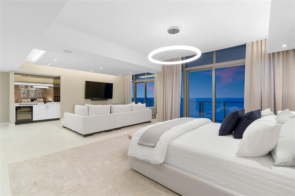 1116 North Ocean Boulevard, Unit UPH03 Pompano Beach, FL 33062 - Photo 27 of 84 a bedroom with bed and flat screen tv