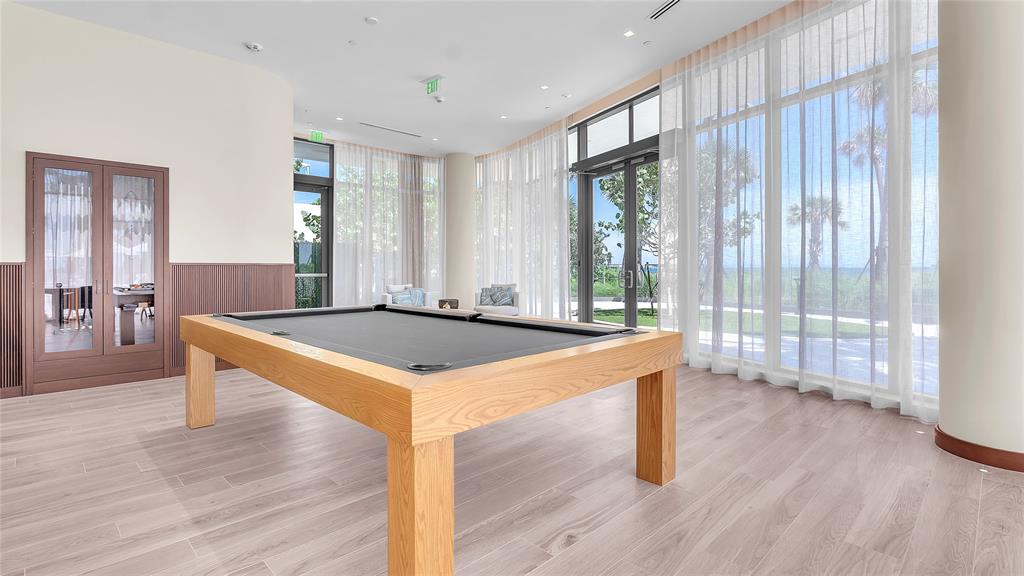 1116 North Ocean Boulevard, Unit UPH03 Pompano Beach, FL 33062 - Photo 79 of 84 a room with wooden floor and glass door