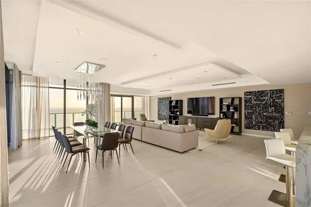 a large kitchen with kitchen island a large counter top space a sink stainless steel appliances and cabinets