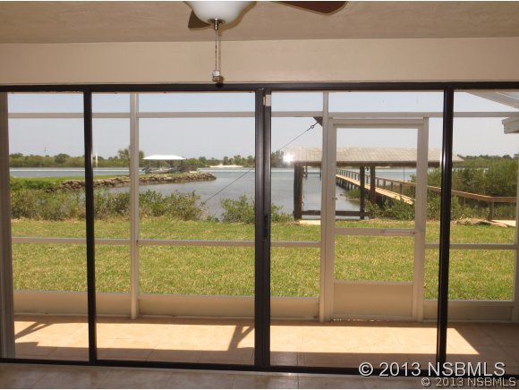 208 Virginia Street Edgewater, FL 32132 - Photo 11 of 15 a view of a glass door with a floor to ceiling windows