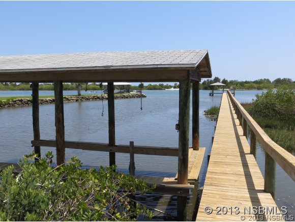 208 Virginia Street Edgewater, FL 32132 - Photo 6 of 15 a view of a balcony with chairs and wooden floor