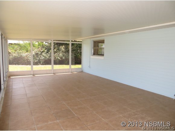 208 Virginia Street Edgewater, FL 32132 - Photo 9 of 15 a view of an empty room with a balcony